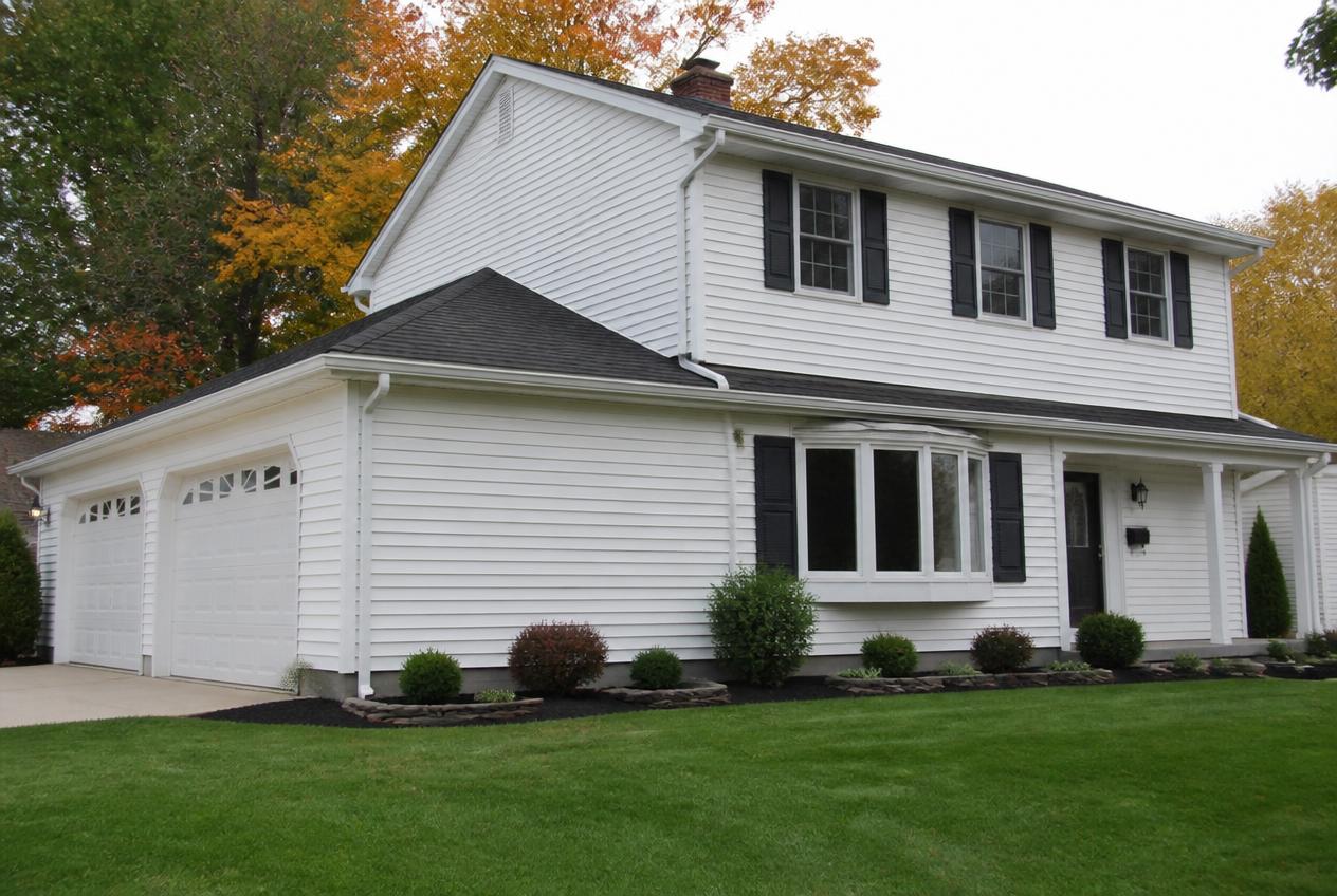 White seamless aluminum gutters and downspouts on a home